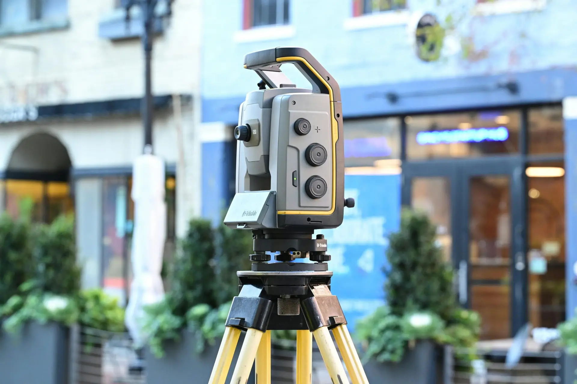 Sophisticated surveying equipment on city street showcasing modern urban mapping technology.